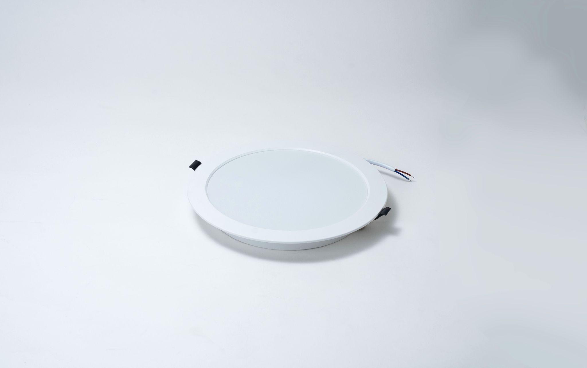 Round recessed LED panel light with a slim white frame, designed for energy-efficient ceiling installation in modern commercial and residential spaces.